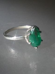 Imperfectly Perfect! This emerald came from a huge lot acquired in the late 70s. The natural inclusions in this stone along with the faceting on the back of the emerald make this ring so unique. This natural 1.56ct emerald is pear shaped cut and pavilion set (back of the stone is set face up). There is a natural clarity characteristic towards the lower tip of pear. Sterling silver mounting has five prongs and a v tip to protect the point of pear. High polished finish band tapers from 1.7 to 1.5 Emerald Solitaire Ring, Aquamarine Solitaire Ring, Aquamarine Studs, Imperfectly Perfect, Ruby Diamond Rings, Silver Prices, How To Make Earrings, Ring Sterling Silver, Pink Tourmaline