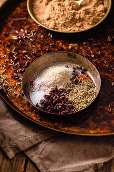 various spices are in bowls on a table