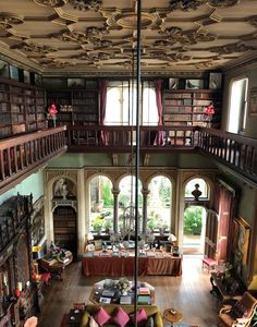 the inside of an old library with many bookshelves and couches in it