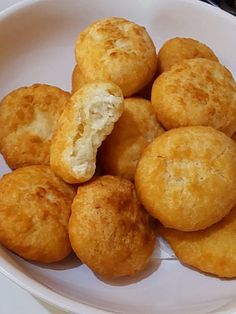 a white bowl filled with fried food on top of a table