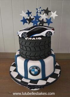 a birthday cake made to look like a car on top of a tire and stars