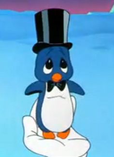 a penguin wearing a top hat and sitting on a pillow