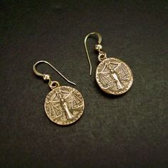 "Handmade antiqued bronze coin charms with the zodiac sign of Libra birthday gift for people born between Sept 23 - Oct 23. Libra are: Cooperative, Diplomatic, Gracious, Fair-minded, Social On those dainty earrings an angel is in the middle overlooking the scale. The concept of the zodiac originated in Babylonian astrology, and was later influenced by Hellenistic culture. According to astrology, celestial phenomena relate to human activity on the principle of \"as above, so below\", so that the Libra Birthday, As Above So Below, Tarpon Springs, Cameo Jewelry, Human Activity, September 23, October 23, Dainty Earrings, Alex And Ani Charm Bracelet