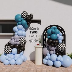 balloons are arranged in the shape of letters and checkered flags, along with a trash can