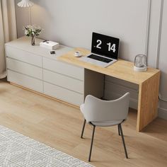 a laptop computer sitting on top of a wooden desk next to a white chair and lamp