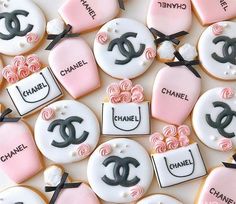 chanel cookies decorated with fondant and icing are arranged on a table top