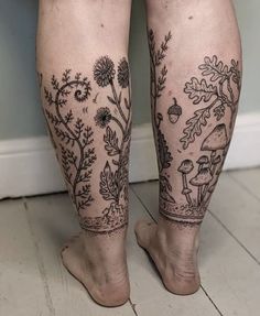 a person with tattoos on their legs is standing in front of a wall and floor