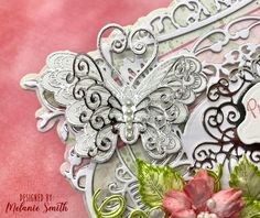 a close up of a card with a butterfly on the front and some flowers on the back