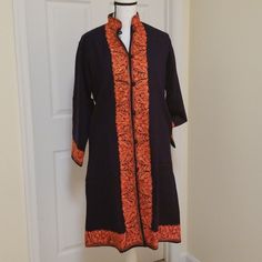 One Of A Kind! Exquisite Hand Embroidered Navy And Orange Coat Long Sleeves, Button Down, Mandarin Collar 2 Side Pockets Front, Back And Cuff Design Floral Embroidery In Shades Of Orange Size M, But May Fit M To L Can Be Worn As A Light Jacket, Top, Midi Abaya, Long Cardigan Handmade By Artisans In Kashmir Pakistan No Inside Tags Or Labels All Specs According To Manufacturer Traditional Fitted Outerwear For Work, Fall Workwear Outerwear With Embroidered Cuffs, Fall Outerwear With Embroidered Cuffs For Work, Embroidered Tailored Kurta For Workwear, Embroidered Fitted Kurta For Work, Fitted Embroidered Kurta For Work, Blue Embroidered Button-up Outerwear, Traditional Embroidered Outerwear For Work, Fitted Kurta With Floral Embroidery For Fall