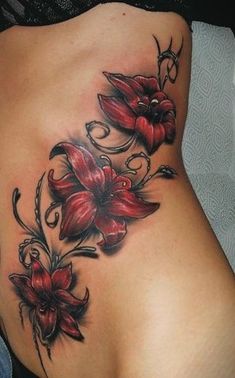 a woman's stomach with red flowers on it