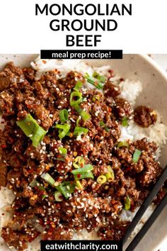 a bowl filled with ground beef and topped with green onions next to chopsticks