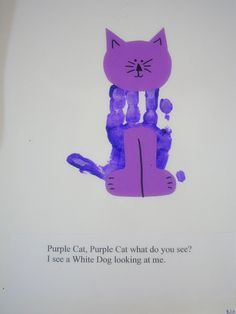 a purple paper cut out of a cat sitting on top of a piece of paper