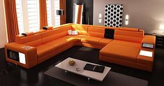 an orange sectional sofa in a modern living room with black flooring and white walls