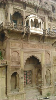 an old building with many windows and balconies on the outside, in india