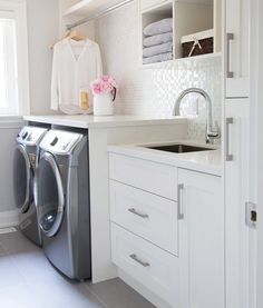 a washer and dryer in a white laundry room