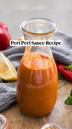 a jar filled with sauce sitting on top of a wooden table next to other ingredients