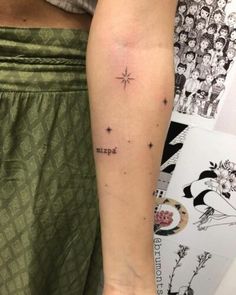 a person with a small star tattoo on their arm