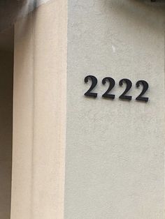 the number 22 is on the side of a white building with black lettering that reads 2232