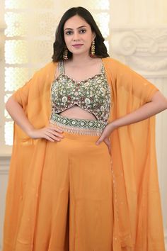 Green cut out blouse with floral zardosi embroidery. Paired with contrasting yellow cape and sharara. - Aza Fashions Blouse And Sharara, Zardosi Embroidery, Tassel Blouse, Mango Blouse, Geometric Sleeve, Hem Blouse, Floral Geometric, Embroidery Floral, Blouse Sleeveless