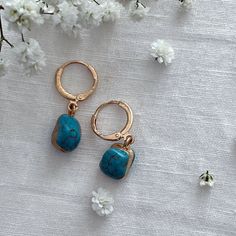 Turquoise Gold Encased Drop Earrings  ☾ ﾟ｡⋆ Details ⋆｡ ﾟ☾ Stone size: Approximately 1cm This listing is for one pair of earrings. The turquoise stones are excellent quality and absolutely stunning. Please note, the stones are organic in shape, as each is charmingly unique, she size and shape of each stone may vary. ☾ ﾟ｡⋆ How to care for your jewellery ⋆｡ ﾟ☾ Although our jewellery is made of high quality materials made to last, to ensure longevity we recommend the following care tips: ● Avoid showering, swimming, and exercising with our pieces ● Polish your pieces every 2 weeks or so, to increase shine and reduce discoloration ● Avoid wearing perfumes with your jewelry ● When not in use, store items in the pouch included in the order ☾ ﾟ｡⋆ Your future awaits ⋆｡ ﾟ☾ In every order, we include Elegant Turquoise Hoop Earrings, Elegant Handmade Turquoise Hoop Earrings, Elegant Everyday Turquoise Earrings, Turquoise Dangle Hoop Earrings For Gift, Blue Dangle Hoop Earrings As Gift, Blue Dangle Hoop Earrings For Gift, Handmade Turquoise Earrings For Gifts, Handmade Turquoise Earrings As Gift, Turquoise Pierced Earrings