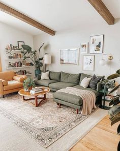 a living room filled with furniture and lots of greenery on the wall next to a large window