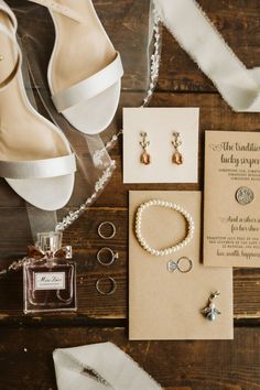 the bride's jewelry and shoes are laid out on the table