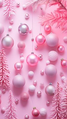 pink and white christmas ornaments on a pink background