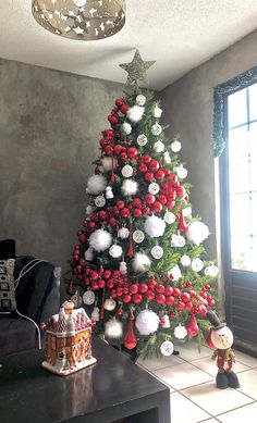 a christmas tree decorated with red, white and silver ornaments