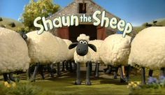 sheep standing in front of a barn with the words shaun the sheep on it