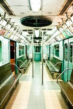 the inside of a subway train with green and brown benches on either side of it