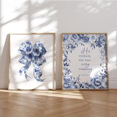 two blue and white framed pictures on the floor