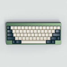 a green and white computer keyboard on a gray surface