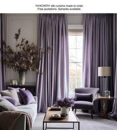 a living room filled with furniture and purple curtains