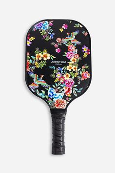 a black paddle with flowers and birds on it