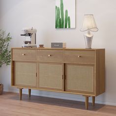 the sideboard is made out of wood and has wicker panels on it's sides