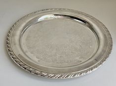 a silver plate sitting on top of a white table