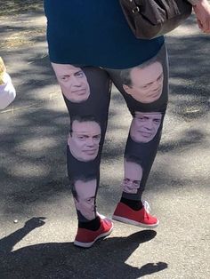 a woman wearing leggings with pictures of people on them