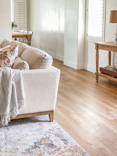 a living room filled with furniture on top of a hard wood floor