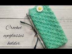 a crochet eyeglass case with a flower on it