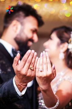 a man and woman holding their hands together