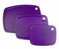 three purple cutting boards with holes in the middle and one on each side, set against a white background