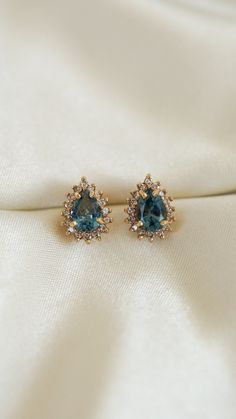 * Earring Material: Blue Topaz, Diamond, 14k Yellow Gold * Earring Dimensions: 11x8.5MM  * Stone Weight & sizes: 2 Blue Topaz - 2ct, Diamond - 0.32ct * Earring Material: 14k yellow gold, Post Back Post   * Overall weight: 3g Diamond Huggie Earrings, Pretty Accessories, Topaz Jewelry, Diamond Stud Earrings, Fancy Jewelry, Gold Earring, Yellow Gold Earring, Diamond Stud, Huggies Earrings