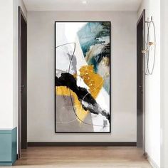 an abstract painting hanging on the wall in a hallway