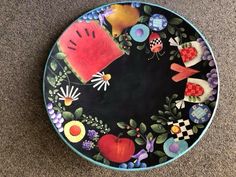 a colorful plate is sitting on the floor