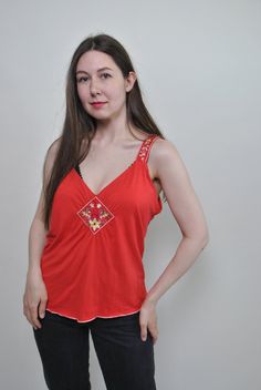 Check out this floral red tank top made of mixed synthetic fabric with flowers embroidery. Good choice for summer festival outfit. Great relaxed top for hippie vibe. Welcome to TARASCOMMON.ETSY.COM Unique clothing from the 20th century. Model tall - 170cm. Size: M. Width - 46cm / 18.11inch; Length - 60cm / 23.62inch. All measurements are taken seam to seam while lying flat. Viscose/ Elastan. This item is vintage, so it can have some defects. Additional photos can be send We are glad that you are Summer Hippie V-neck Top, Bohemian Tank Top With Floral Embroidery, Orange V-neck Tank Top For Spring, Spring Orange V-neck Tank Top, Summer Tank Top With Floral Embroidery For Vacation, Floral Embroidered Tank Top For Summer, Orange Camisole Tank Top For Spring, Cotton Cami Tank Top With Floral Embroidery, Summer Floral Embroidery Tank Top For Vacation