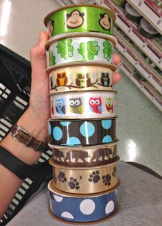 a person holding up a stack of washi tapes