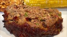 meatloaf with cranberry sauce and corn on the cob is ready to be eaten