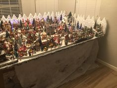 a christmas village is displayed on a table