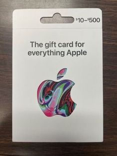 the gift card for everything apple has been placed on top of a wooden table,