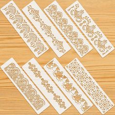 four different types of decorative stencils on a wooden surface, each with an intricate design